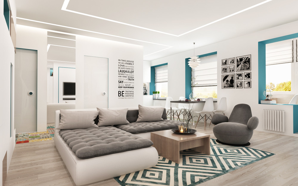 Appartement moderne de 50 m² avec canapé gris, tapis graphique et décoration turquoise