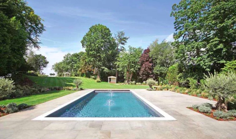 Piscine extérieure enterrée avec terrasse et jardin