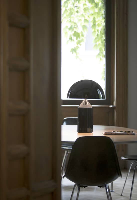 lampe design atollo noir posée sur une table